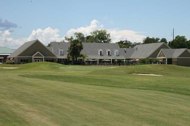 A view of a green and the clubhouse at Cypress Lakes Country Club.