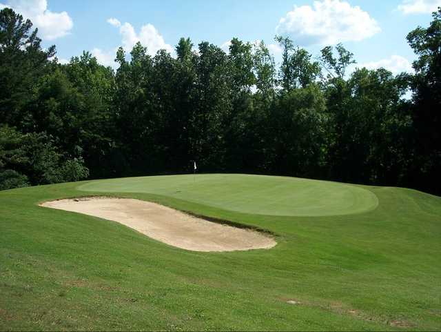 A view of a green protected by a bunker from Cumberland Lake Golf Course