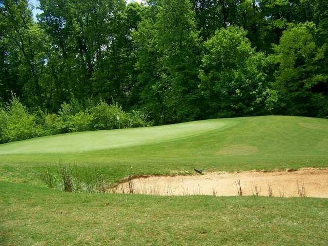A view of a hole protected by a bunker at Williams Creek Golf Course