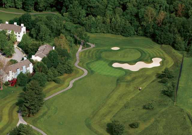 A view of a green flanked by tricky sand traps at Fairway Hills Golf Club