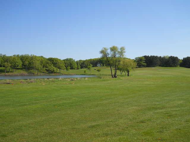 A view from the 14th fairway with a pond on the left side at Kimball Golf Club