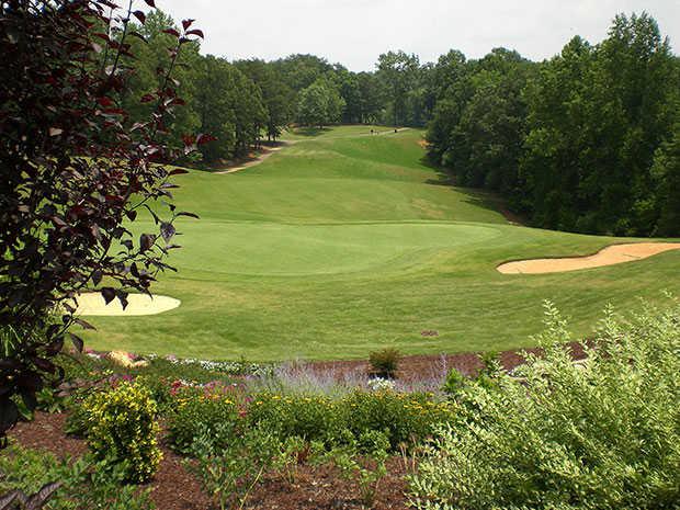 A view of a hole and a fairway at Cleghorn Golf & Sports Club.