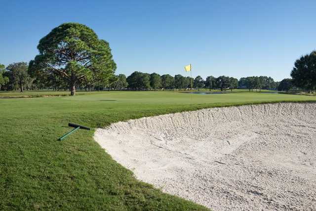 A view of a green protected by a large bunker at Eagles Golf Club