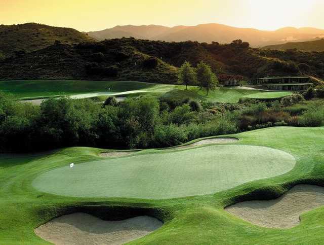A view of a green protected by bunkers at Dove Canyon Country Club