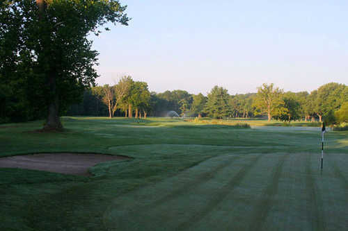 A view of a hole protected by a bunker at Sweet Water Golf Course