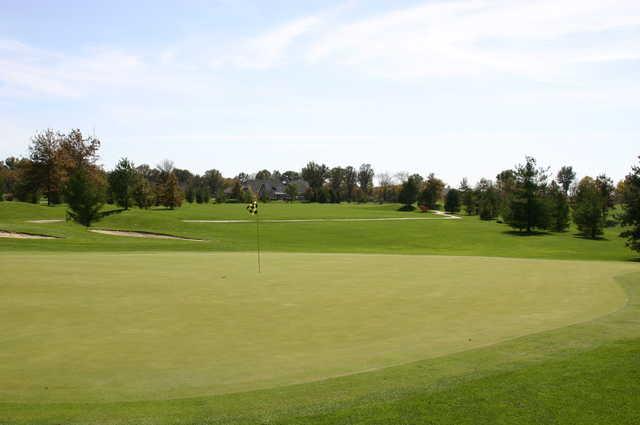 A fall view of the 2nd green with a narrow path in background from Championship at Governors Run Golf & Country Club