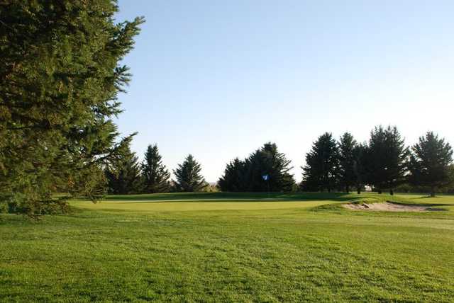 A view of a hole protected by a bunker at Raymond Golf Course