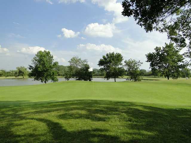 A view of a hole with water in background at Odyssey Golf Course