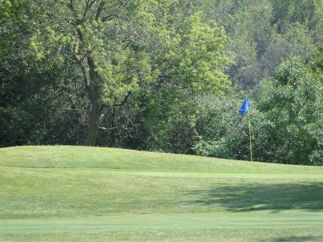 A sunny day view of a hole at Odyssey Golf Course