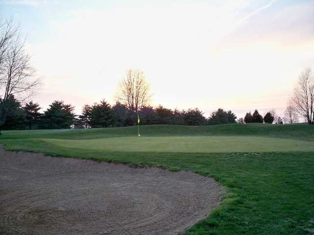 A fall view of a green protected by a large bunker at The Pines from Lindsey Wilson