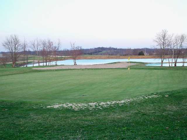 A view of a green with water in background at The Pines from Lindsey Wilson