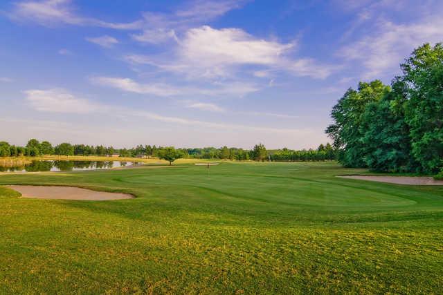 A view of a green with water and bunkers coming into play at Applewood Golf Course