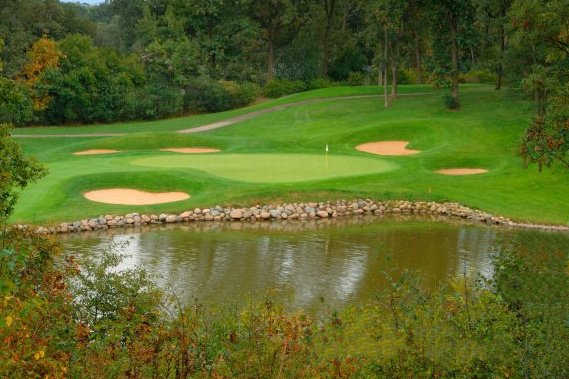 A view of a green with bunkers and water coming into play at Crystal Tree Golf & Country Club