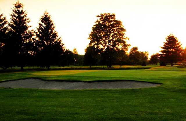 A view of a green guarded by a bunker at Burford Golf Links