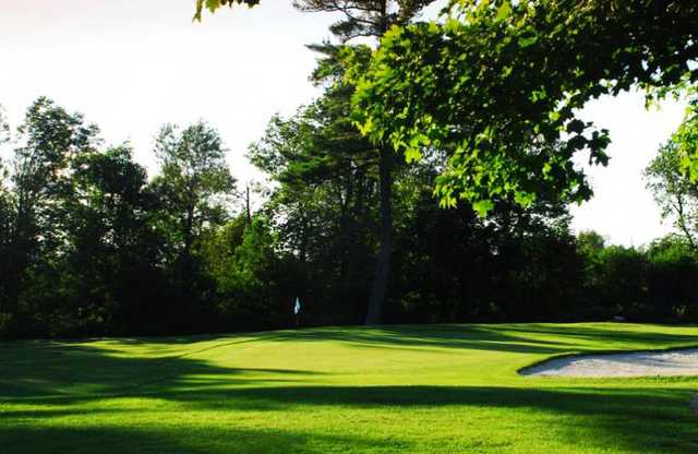 A view of a green with a bunker on the right side at Beaverdale Golf Club