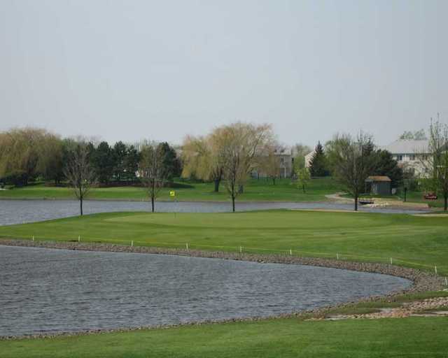 A view over the water of a green at Walnut Greens Golf Course.