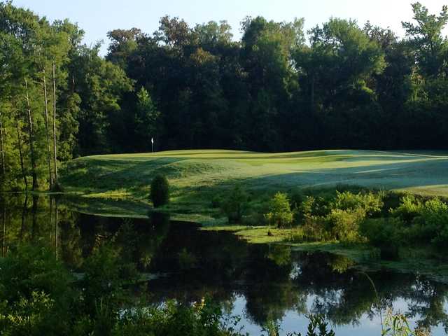 A view over the water of the 14th hole at Grand Bear Golf Course