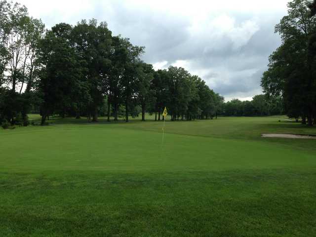 A view of a hole protected by a bunker at Preakness Valley Golf Course