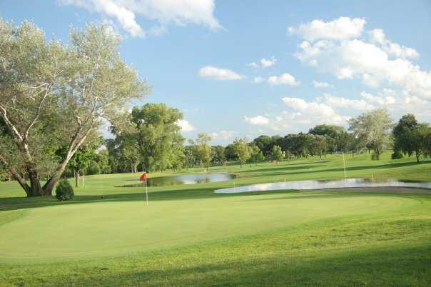 A view of a green with water coming into play at Highland National Golf Course