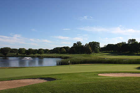 A view of hole #17 protected by a pond and bunkers at Mendakota Country Club
