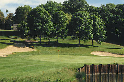 A view of a green flanked by sand traps at Tartan Park Golf Course