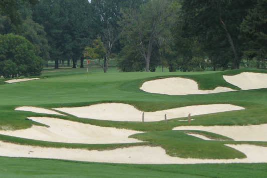 A view of a hole protected by a collection of tricky bunkers at Meadowbrook Country Club