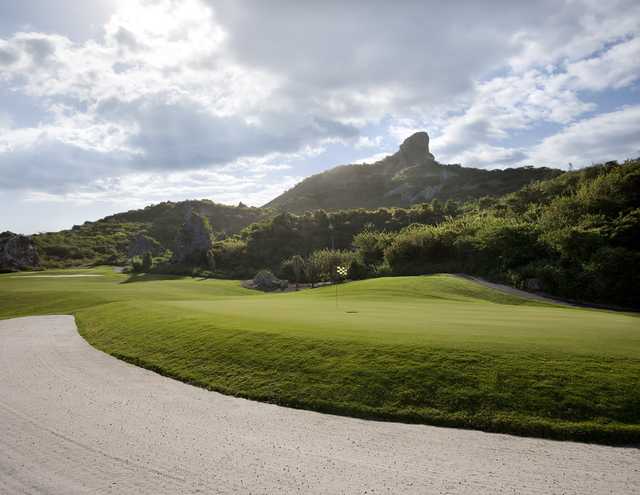 A view of a green guarded by a large bunker at Old Quarry Golf Course
