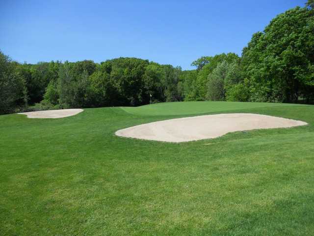 A view of a green protected by sand traps at Woodhaven Country Club