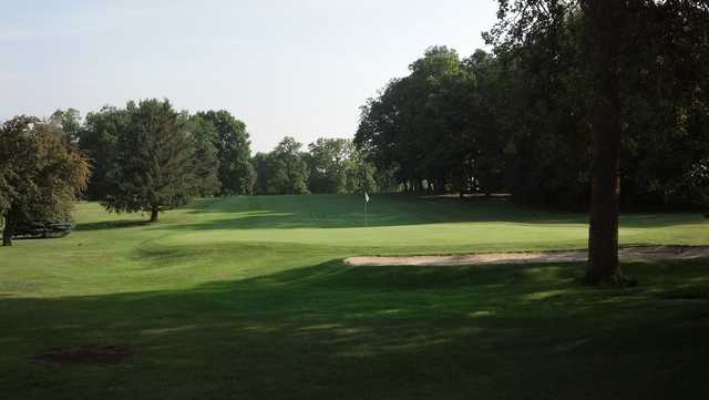 A view of a green protected by a bunker at Turtle Creek Golf Course