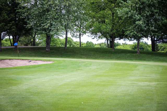 A view of a hole protected by a bunker at Eagle Trace Golf Course