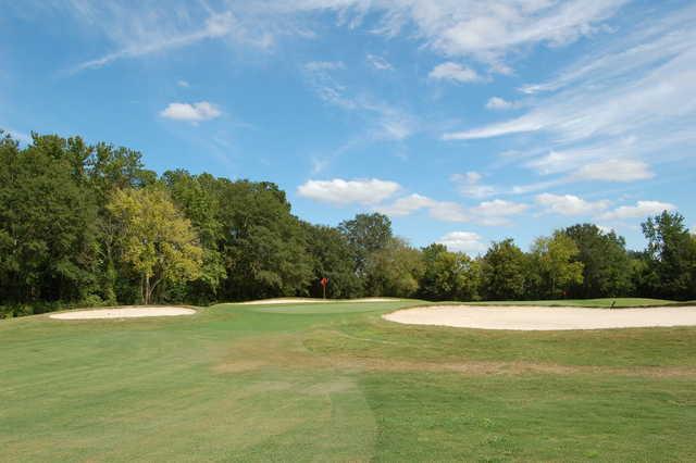 A view of a green protected by a collection of bunkers at Hillcrest Golf Course