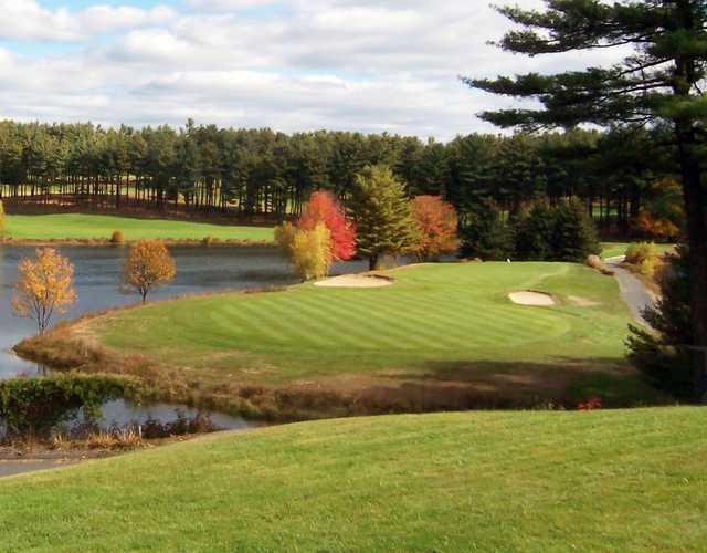 A view of a green protected by bunkers at Pequabuck Golf Club