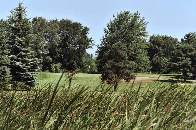 A view of a hole protected by a bunker at Maple Creek Golf Club