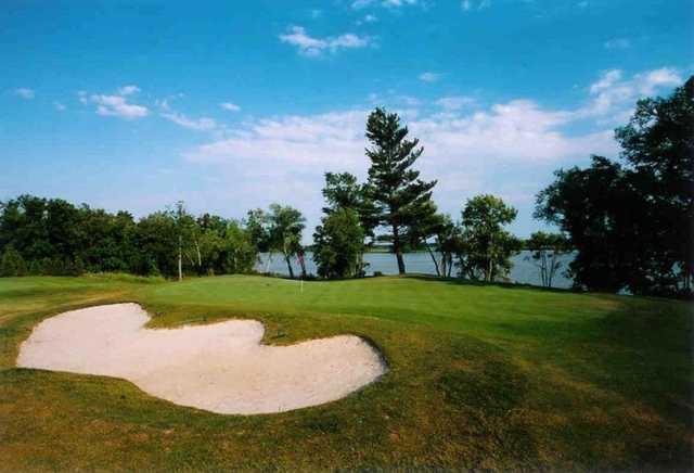 A view of a green with water in background at Dunnville Golf and Country Club