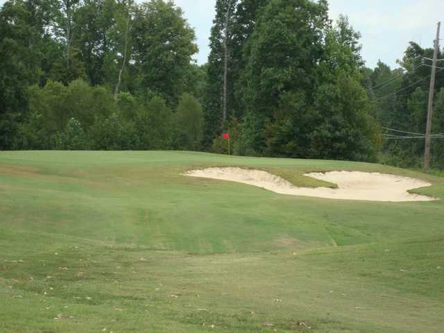 A view of a green protected by a bunker at Bent Tree Golf Club