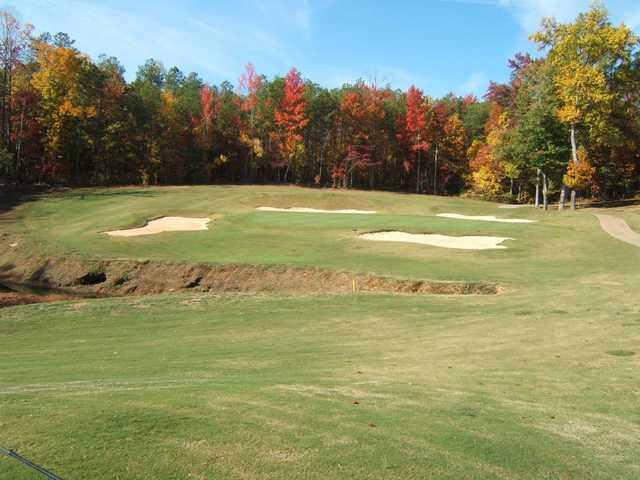 A view of a hole guarded by a collection of bunkers at St. Andrews Golf Club.