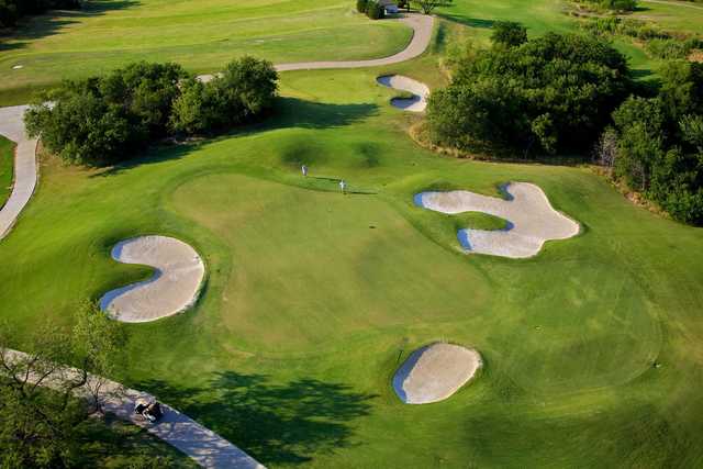 A view of a hole surrounded by a collection of sand traps at Tangle Ridge Golf Club