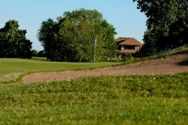 A view of a hole protected by a bunker at Mill Creek Golf Club