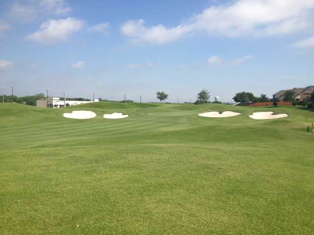 A view of a green protected by two pairs of bunkers on each side at WestRidge Golf Course