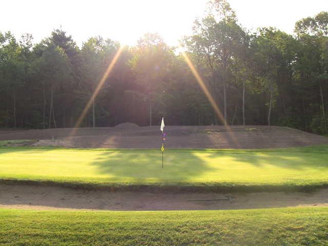 A view of the 1st hole protected by a bunker at Harmony Golf Club