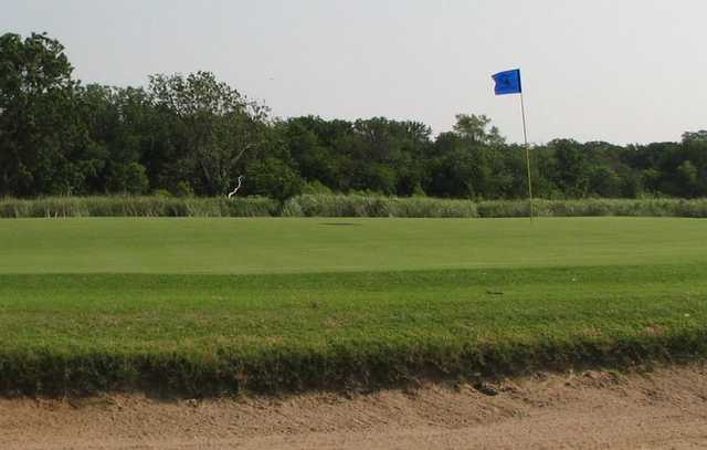 A view of a green protected by a sand trap at Falconhead Resort & Country Club