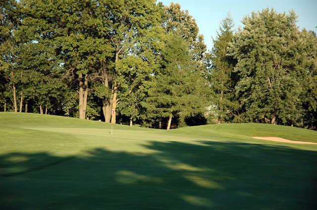 A view of a green protected by a bunker at Reedsburg Country Club