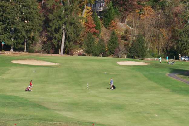 A view of a green flanked by sand traps at Asheville Golf Course