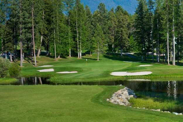 A view of a green protected by a collection of bunkers at Meadow Lake Golf Resort