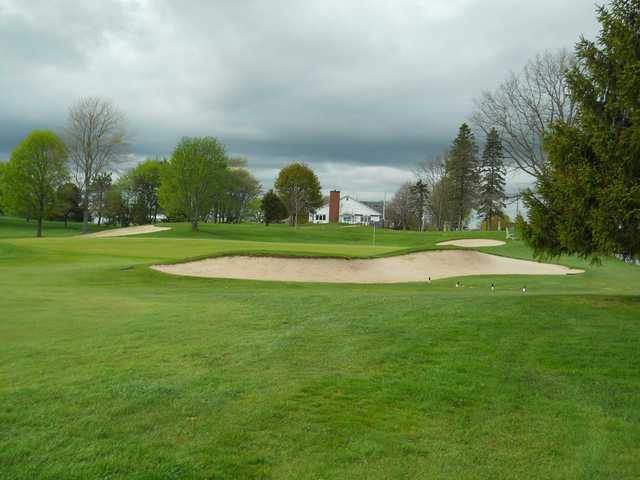 A view of a green protected by sand traps at Truro Golf Club