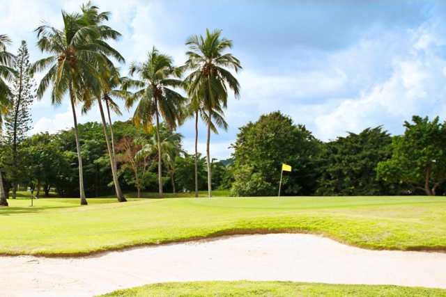 A view of a hole protected by a bunker at Fort Buchanan Golf Course