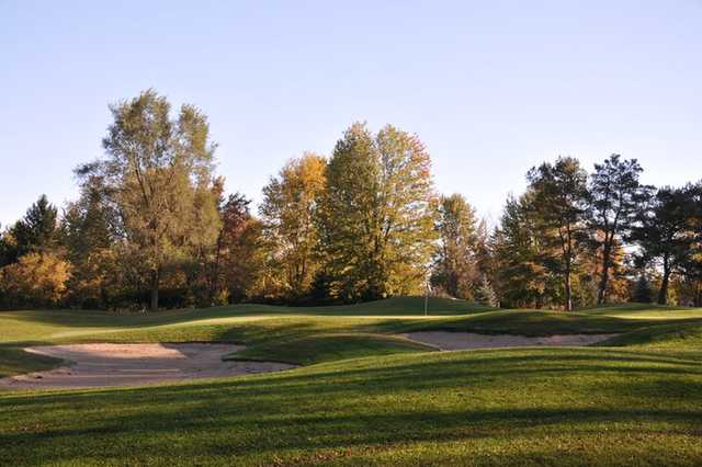 A view of a green protected by sand traps at Currie Golf Course