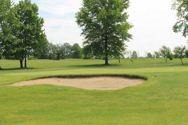 A view of a hole guarded by a bunker at Raintree Country Club