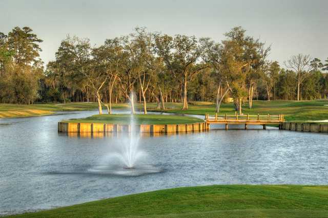 A view of a green surrounded by water at Heritage Oaks Golf Club