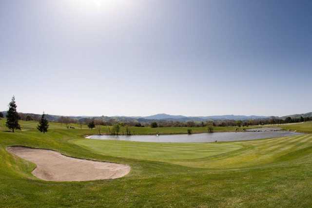 A view of a green with water coming into play at Coyote Creek Golf Club